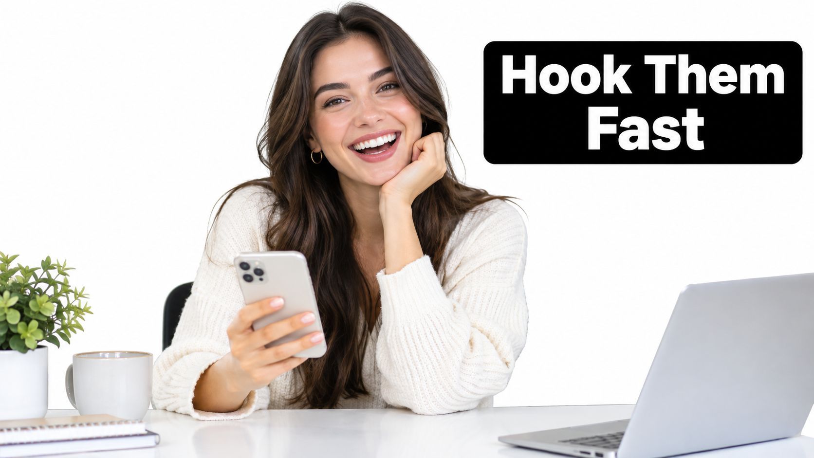A smiling young woman sitting at a desk with a laptop and phone, representing digital marketing success.
